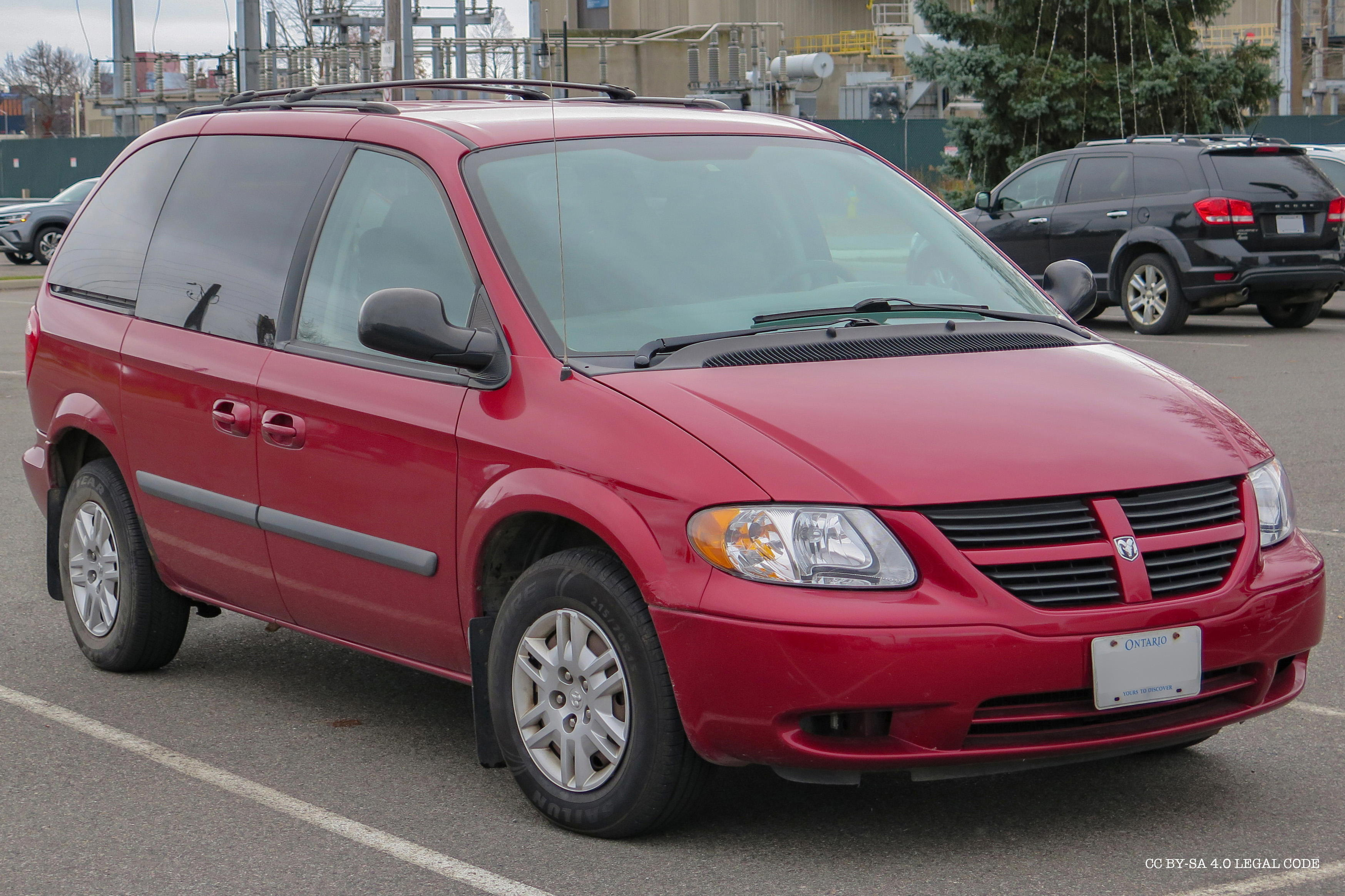 uploads/2007_Dodge_Caravan_Base_in_Inferno_Red_Crystal_Pearl,_Front_Right,_11-12-2022.jpg
